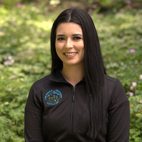 Young Woman Smiling By Green Wall