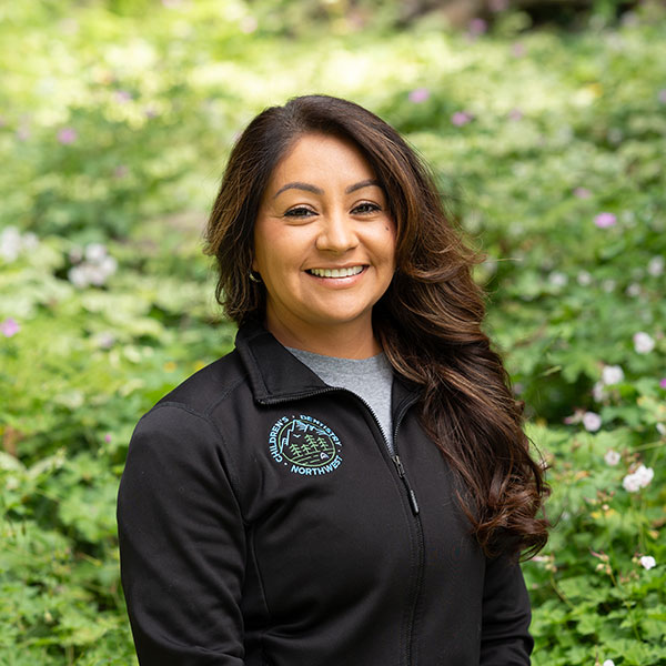 Erika Young Woman Smiling By Green Wall