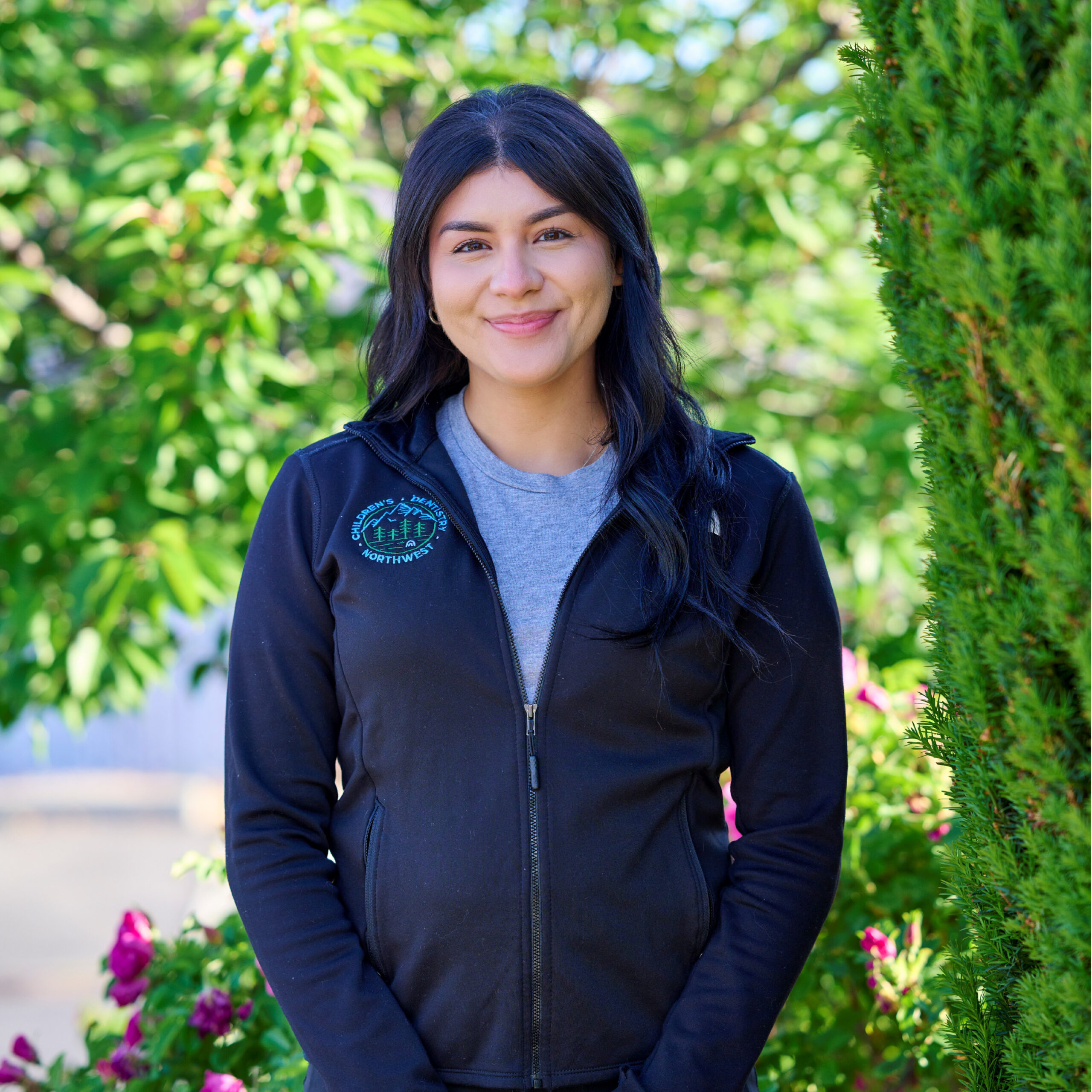 Yari 2025 readjusted Young Woman Smiling By Green Wall